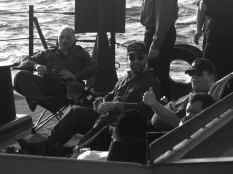 Sergeant Santa, Pat, and Gilles relaxing on the quarter deck